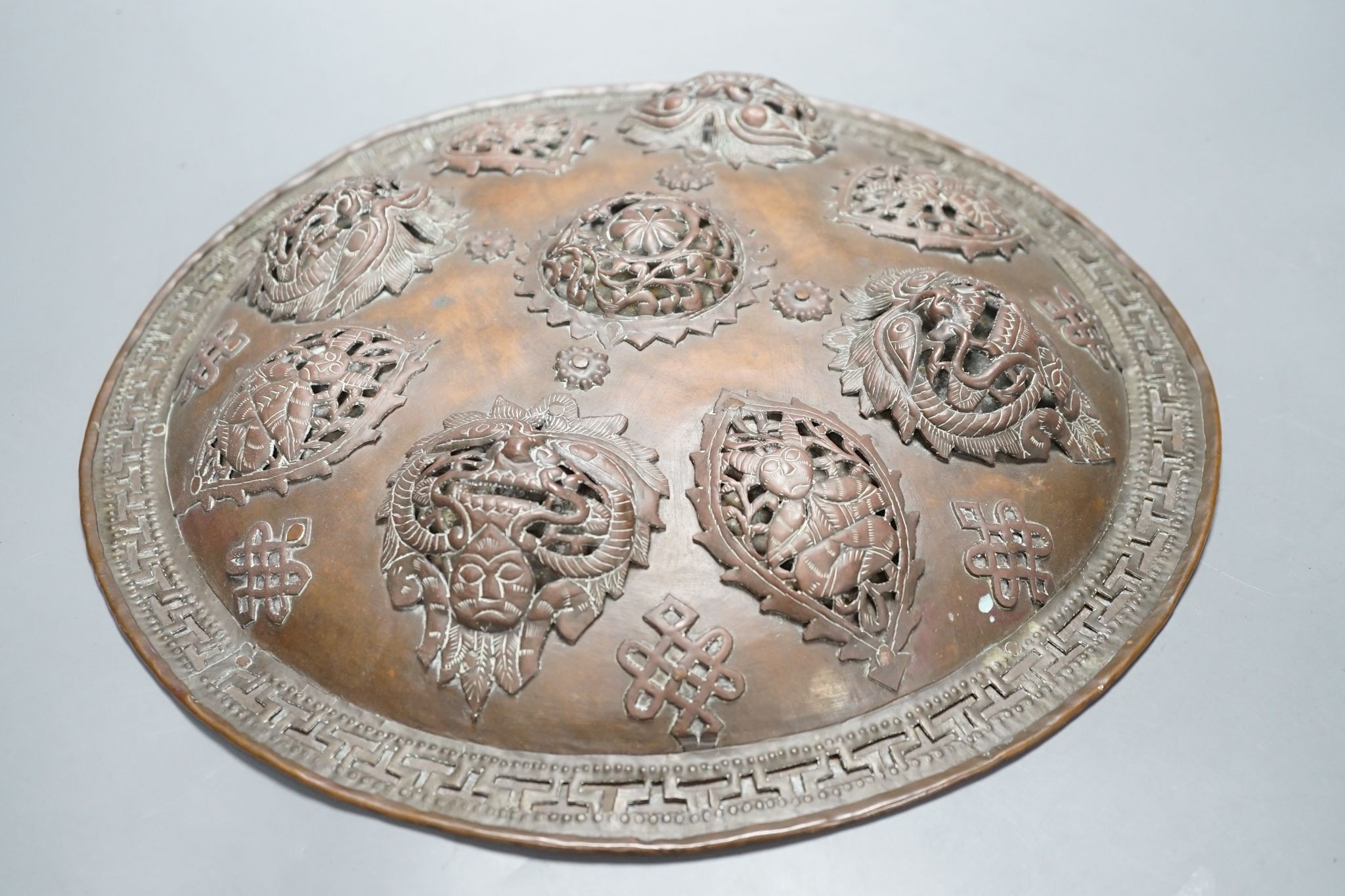 A Persian circular copper shield, 35.5 cms diameter.